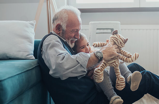 Senior home care client spending quality time with grandchildren.